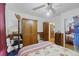 Bedroom with hardwood floors, paneling, a ceiling fan, and closet storage at 212 Columbia Dr, Ladson, SC 29456