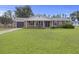 Beautiful single-story brick home with a covered porch, attached garage, and manicured lawn at 212 Columbia Dr, Ladson, SC 29456