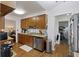 A vintage style kitchen featuring wooden cabinets and a stainless steel dishwasher at 212 Columbia Dr, Ladson, SC 29456