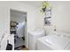 Bright laundry room with washer, dryer, storage shelves and a view to the backyard at 212 Columbia Dr, Ladson, SC 29456
