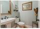 Elegant powder room features a pedestal sink, decorative mirror, and tasteful artwork at 216 Foxbank Plantation Blvd, Moncks Corner, SC 29461