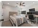Bedroom has a ceiling fan, a grey padded headboard, and plenty of desk space for work at 216 Foxbank Plantation Blvd, Moncks Corner, SC 29461