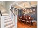 Elegant dining room with coffered ceiling, wooden floors, chandelier, and a long table set for dinner at 216 Foxbank Plantation Blvd, Moncks Corner, SC 29461