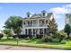 Charming two-story home featuring double porches, dormer windows, and a well-manicured front lawn at 216 Foxbank Plantation Blvd, Moncks Corner, SC 29461