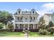 Charming two-story home featuring double porches, dormer windows, and a well-manicured front lawn at 216 Foxbank Plantation Blvd, Moncks Corner, SC 29461