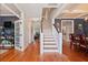 Traditional foyer with wooden floors, a staircase, and views into the dining room and living area at 216 Foxbank Plantation Blvd, Moncks Corner, SC 29461