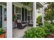 Inviting front porch with comfortable seating, ferns, and beautiful green landscaping at 216 Foxbank Plantation Blvd, Moncks Corner, SC 29461