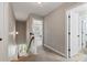 Well-lit hallway with carpeted floor and view of the staircase to the front door at 216 Foxbank Plantation Blvd, Moncks Corner, SC 29461