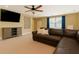 Comfortable living room boasts a leather couch, large TV, ceiling fan, and plenty of natural light at 216 Foxbank Plantation Blvd, Moncks Corner, SC 29461
