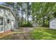 A large backyard shows mature trees and a shed for extra storage at 217 Quaker Rd, Saint George, SC 29477