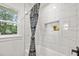 Bathroom with white marble tiled shower and a patterned shower curtain at 217 Quaker Rd, Saint George, SC 29477