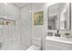 Stylish bathroom featuring marble tile, a vanity with a black faucet, and a mirror at 217 Quaker Rd, Saint George, SC 29477