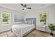 Bright bedroom with a ceiling fan, light wood floor, and accent wall art at 217 Quaker Rd, Saint George, SC 29477