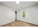 Unfurnished bedroom with a closet, a window, and wood flooring at 217 Quaker Rd, Saint George, SC 29477
