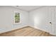 Bright bedroom features wood floors, white walls, and a sun-filled window at 217 Quaker Rd, Saint George, SC 29477