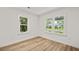 Sunlit bedroom with two windows and wood flooring at 217 Quaker Rd, Saint George, SC 29477