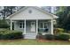Charming home featuring a covered porch, round window, and freshly landscaped front yard at 217 Quaker Rd, Saint George, SC 29477