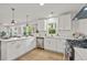 Bright kitchen features white cabinetry, stainless steel appliances, and a functional layout for cooking and entertaining at 217 Quaker Rd, Saint George, SC 29477