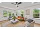 Sun-drenched living room showcasing contemporary furnishings, a ceiling fan, and large windows at 217 Quaker Rd, Saint George, SC 29477
