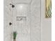 Elegant marble tiled shower with a built-in niche and black hardware at 217 Quaker Rd, Saint George, SC 29477