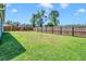 Large backyard with green grass, wooden fence and swing set at 224 Sugarhouse Ct, Moncks Corner, SC 29461