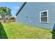 A home's backyard features a wooden swing set and fenced in yard with green grass at 224 Sugarhouse Ct, Moncks Corner, SC 29461