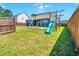Backyard with a wooden swing set and green slide with a partially fenced in yard at 224 Sugarhouse Ct, Moncks Corner, SC 29461