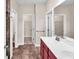Bathroom featuring a double sink vanity, tile flooring and two open doors to walk-in closets at 224 Sugarhouse Ct, Moncks Corner, SC 29461