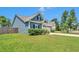 Bright blue home with manicured landscaping, dormers, and a two-car garage at 224 Sugarhouse Ct, Moncks Corner, SC 29461