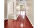 Hallway with hardwood floors leading to rooms with carpet and natural light at 224 Sugarhouse Ct, Moncks Corner, SC 29461