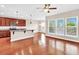 Open living space with a view of the kitchen, hardwood floors, and lots of natural light at 224 Sugarhouse Ct, Moncks Corner, SC 29461
