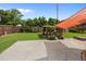 Lush backyard featuring a vibrant garden shed, concrete patio and a cozy orange awning at 2651 Martha Dr, North Charleston, SC 29405