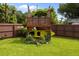 Backyard area featuring an elevated platform with chairs and a kayak underneath, surrounded by greenery at 2651 Martha Dr, North Charleston, SC 29405