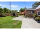 Large backyard with concrete patio, lush lawn, shed and brick house featuring an orange awning at 2651 Martha Dr, North Charleston, SC 29405