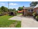 Brick home exterior with a large backyard featuring a shed, a concrete patio, and a garden at 2651 Martha Dr, North Charleston, SC 29405