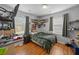 A bedroom has hardwood floors, two windows, and a car poster on the wall at 2651 Martha Dr, North Charleston, SC 29405