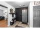 Front entrance features a gray door and a black accent wall with mounted shelves at 2651 Martha Dr, North Charleston, SC 29405