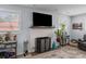 Close-up of a fireplace with white brick surround, large TV above, and stylish decor at 2651 Martha Dr, North Charleston, SC 29405