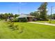 Beautifully landscaped front yard with a brick home featuring a cozy porch and green lawn at 2651 Martha Dr, North Charleston, SC 29405