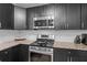 A kitchen features stainless steel appliances, granite countertops, and dark cabinets at 2651 Martha Dr, North Charleston, SC 29405