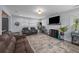 Comfortable living room with a brick fireplace, large TV, and plush, leather seating at 2651 Martha Dr, North Charleston, SC 29405