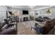 Cozy living room with fireplace, large screen TV, comfortable couches, and wood-look floors at 2651 Martha Dr, North Charleston, SC 29405