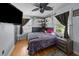 A bedroom with hardwood floors, modern decorations, a ceiling fan, and a large window at 2651 Martha Dr, North Charleston, SC 29405
