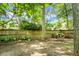 A beautiful wooded back yard with a privacy fence provides a natural setting for outdoor enjoyment at 2701 Four Winds Pl, Mount Pleasant, SC 29466