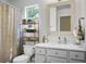Charming bathroom with white vanity, decorative mirror, and coordinated accessories at 2701 Four Winds Pl, Mount Pleasant, SC 29466