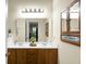 Well-lit bathroom featuring a double vanity, modern fixtures, and a decorative medicine cabinet at 2701 Four Winds Pl, Mount Pleasant, SC 29466