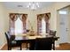 Dining room featuring a chandelier and a dark wood table set for four at 2701 Four Winds Pl, Mount Pleasant, SC 29466