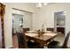 Dining room with a dark wood table set for four, visible kitchen and living room at 2701 Four Winds Pl, Mount Pleasant, SC 29466