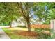 This home has a lush green front yard with beautiful trees and landscaping at 2701 Four Winds Pl, Mount Pleasant, SC 29466
