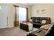 Cozy living room featuring a leather sofa, ottoman, and ample natural light at 2701 Four Winds Pl, Mount Pleasant, SC 29466